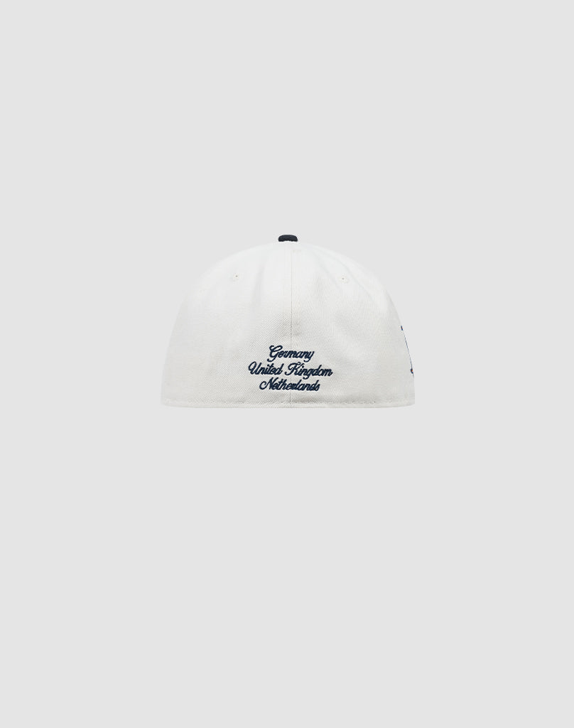 A white LFDY X NEW ERA 59FIFTY fitted cap by LIVE FAST DIE YOUNG, shown from the back with blue Germany United Kingdom Netherlands embroidery near the bottom. Plain light gray background. Größentabelle available for sizing.