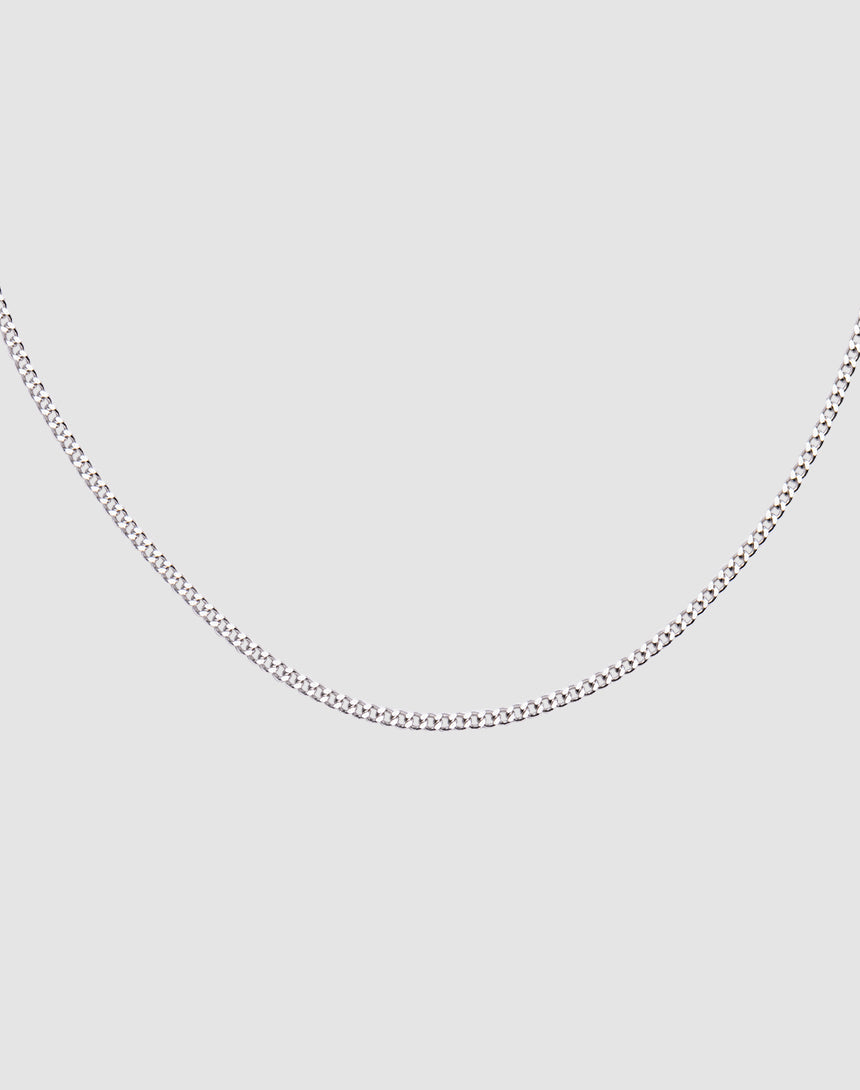 The LIVE FAST DIE YOUNG Round Box Chain, a slim 925 Sterling Silver necklace with adjustable length, is displayed on a plain light gray background and forms a gentle curve.
