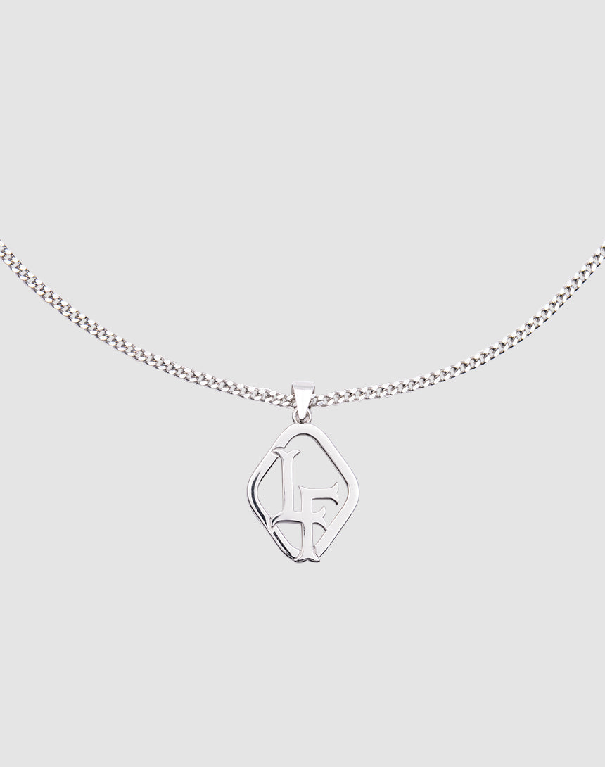 The LF Blank Chain by LIVE FAST DIE YOUNG is a 925 Sterling Silver necklace with a delicate, adjustable chain and a geometric pendant featuring intertwined L and F letters, shown on a plain light gray background.