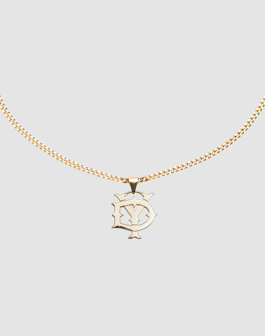 The DY Blank Chain by LIVE FAST DIE YOUNG is a gold necklace featuring a 925 Vergoldet Sterling Silber pendant with an intricate Y and S design inside an outlined shape, displayed on a plain light gray background.