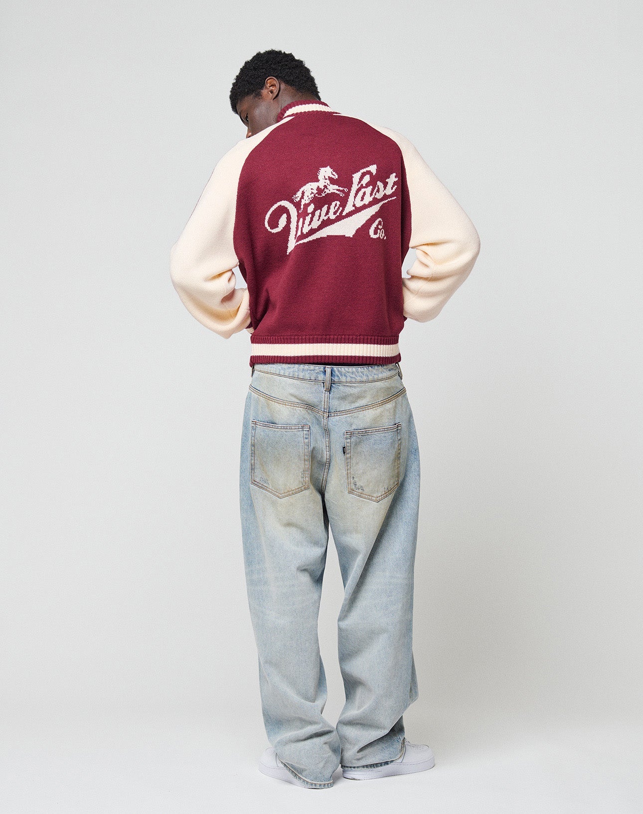 Close-up of a maroon Boxy Knit Zip Jacket by LIVE FAST DIE YOUNG, with white galloping horse graphic and “Live Fast” in cursive above it, in an Oversize Fit.