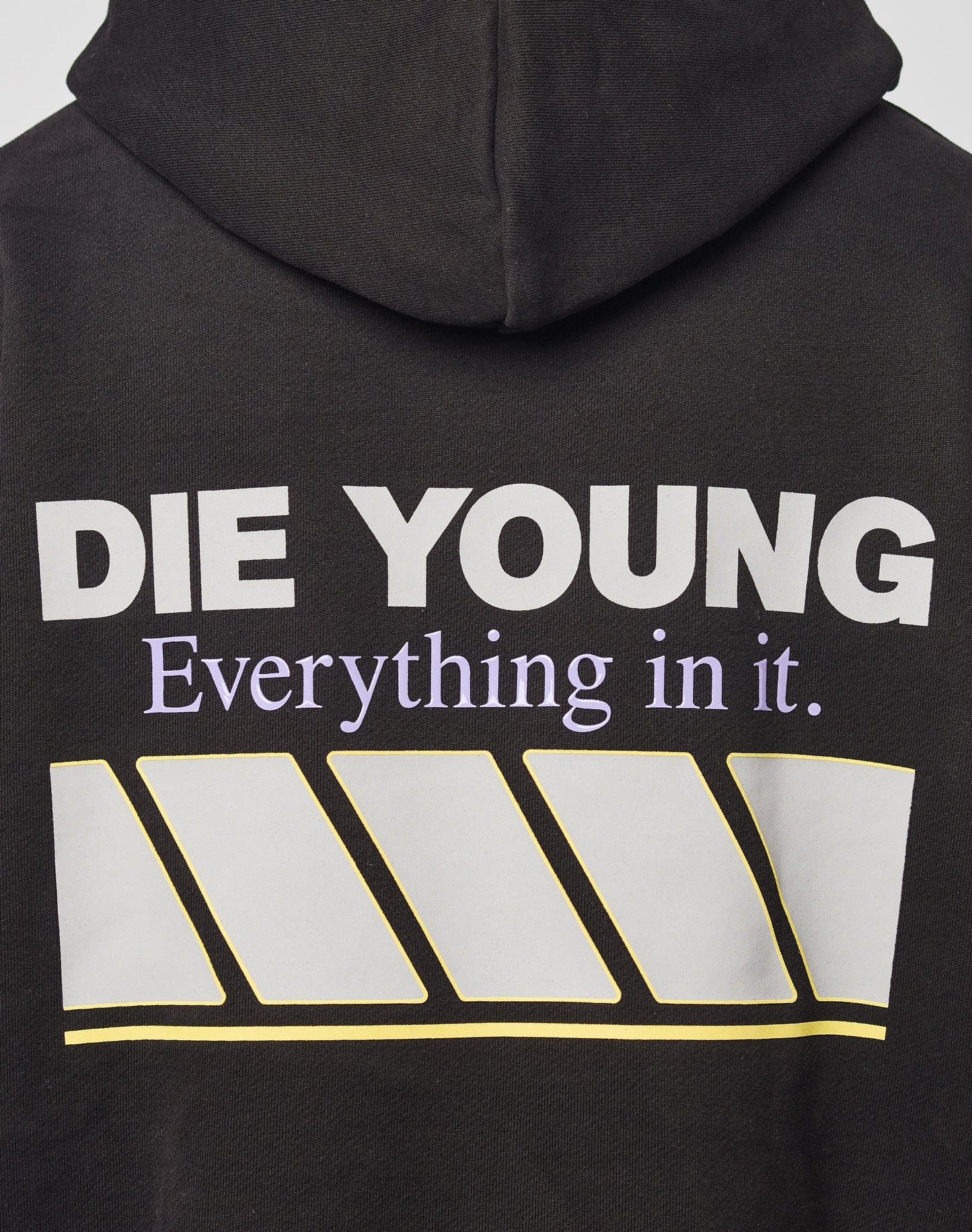 The LFDY Racing Hooded by LIVE FAST DIE YOUNG is a black oversized hoodie with bold white DIE YOUNG text above smaller purple Everything in it, four yellow-outlined white diagonal bars, and a glossy Baumwolle Polyester finish.