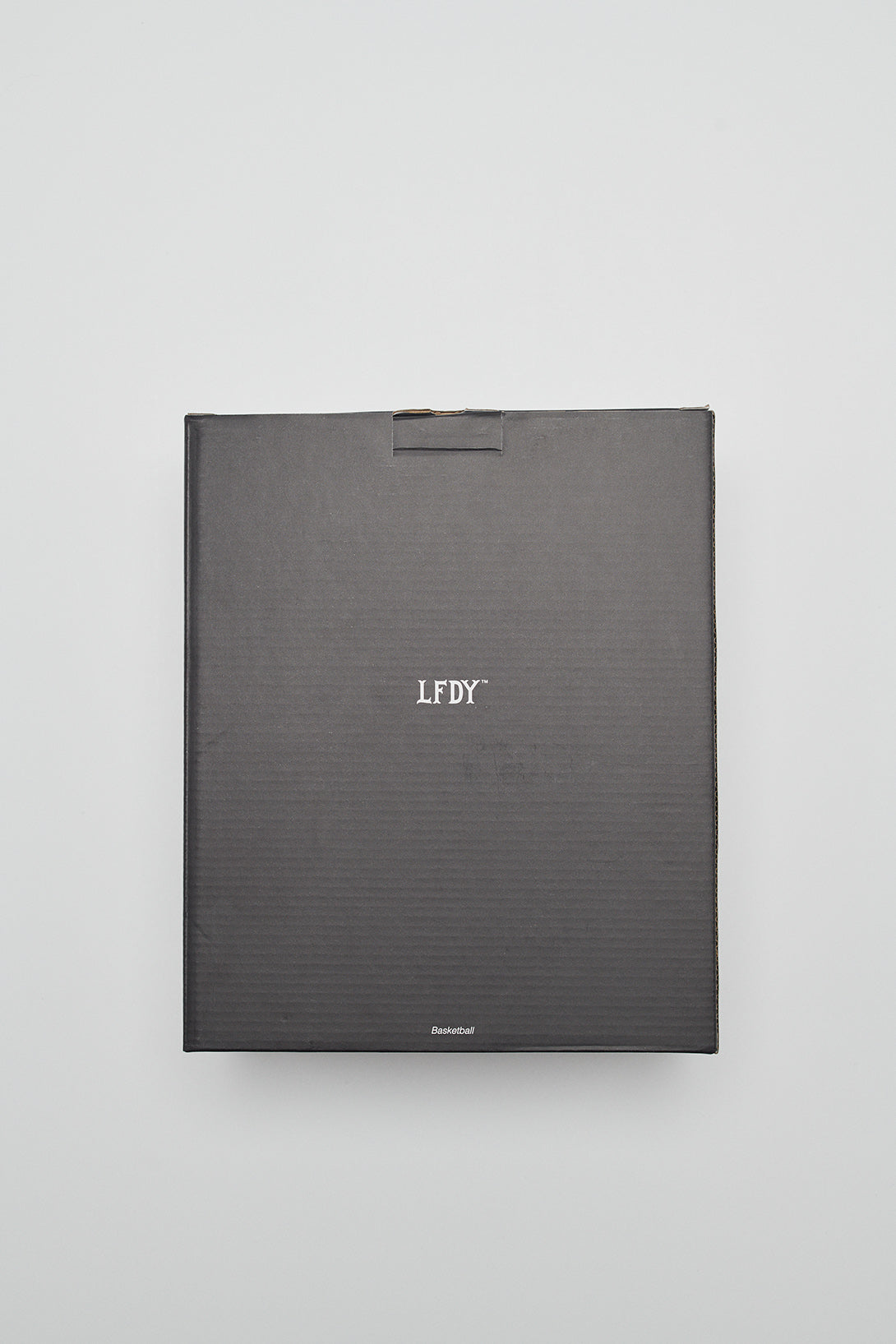 A matte black, square Live Fast Basketball box from LIVE FAST DIE YOUNG, with deep grooves and white LFDY lettering centered on the lid, set against a plain light gray background.