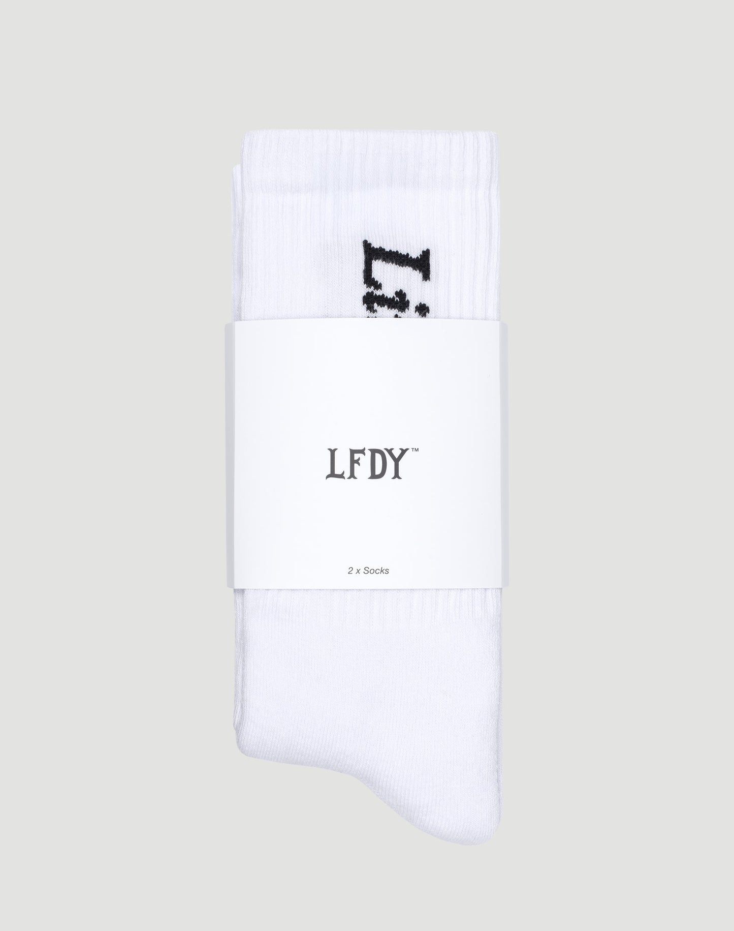 A pair of soft white Live Fast Die Young Socks (2 Pack) by LIVE FAST DIE YOUNG, made from Baumwolle with Polyamid and Elastan, folded together and wrapped in a white band labeled LFDY™ and 2 x Socks, set on a light gray background.