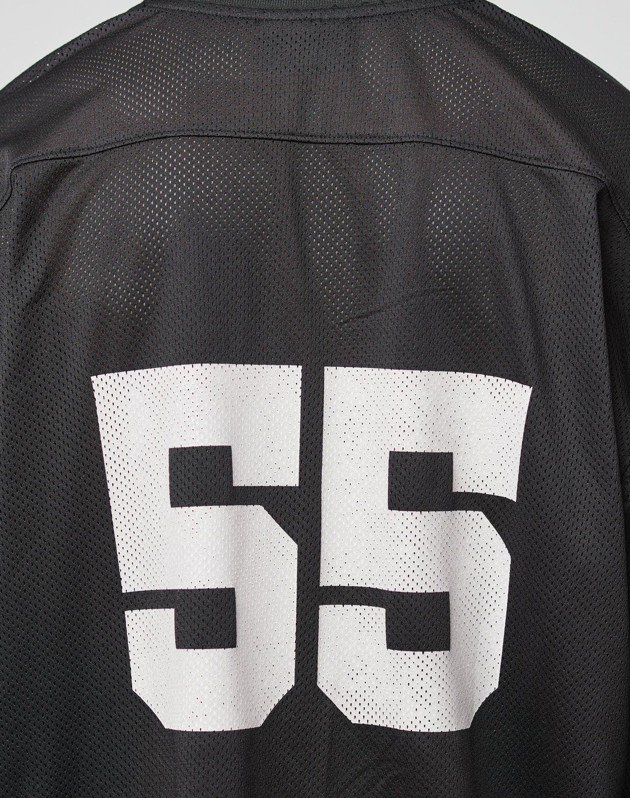 The LFDY Mesh Jersey by LIVE FAST DIE YOUNG is a black sports top with a bold white 55 on the back, crafted from breathable polyester mesh. It features an oversized fit and V-Ausschnitt for athletic style and comfort.
