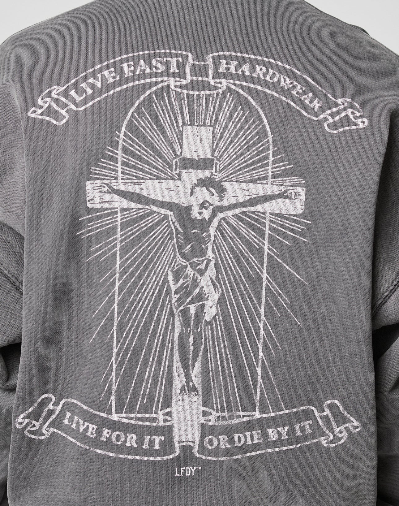 The LFDY Cross Hooded Zip by LIVE FAST DIE YOUNG is a gray oversized hoodie with a Jesus-on-the-cross graphic, rays of light, “LIVE FAST HARDWEAR” and “LIVE FOR IT OR DIE BY IT” text, LFDY initials, and subtle distressed details.