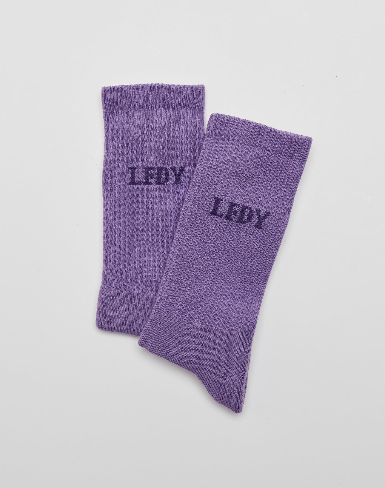 A pair of LIVE FAST DIE YOUNG LFDY Logo Socks (2 Pack) in purple, crafted from soft Baumwolle, featuring black LFDY logo print on top, displayed flat on a white surface.