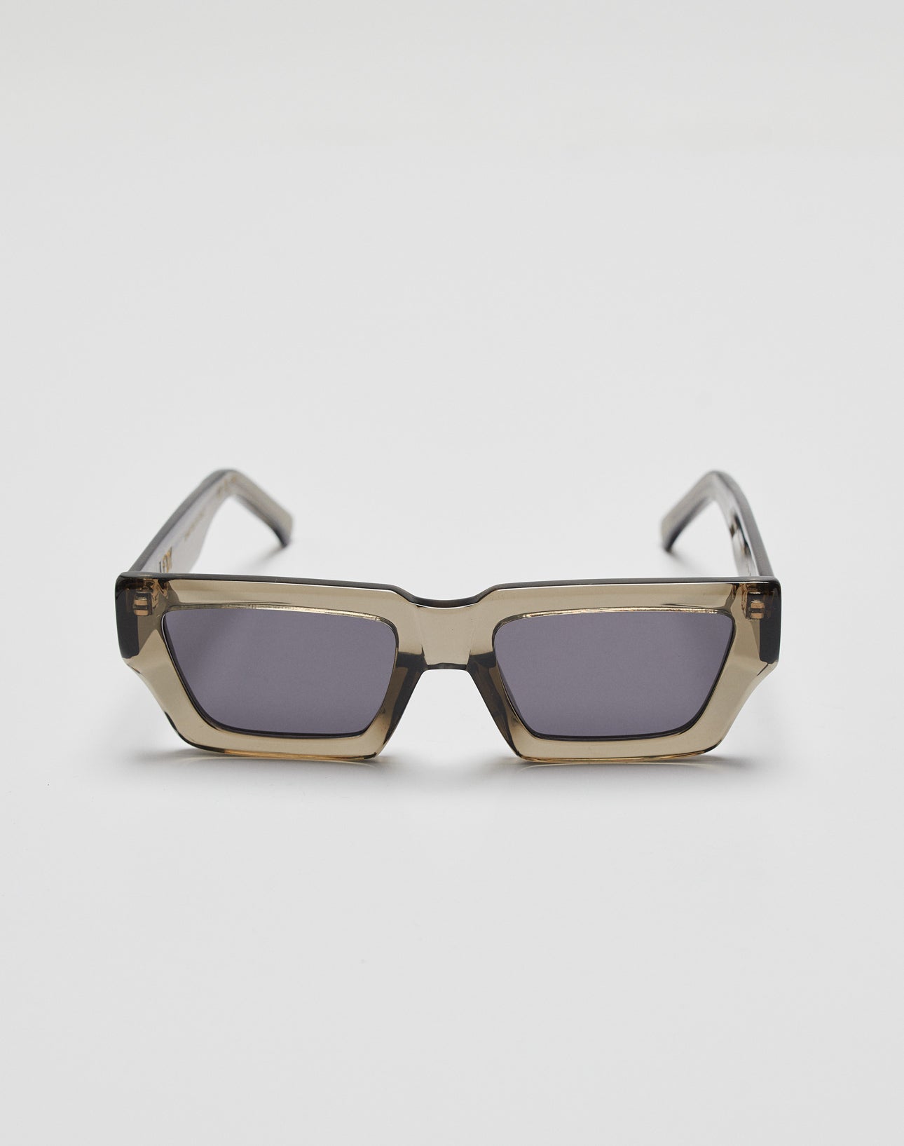 LIVE FAST DIE YOUNGs Live Fast Sunglasses feature rectangular grey-tinted lenses and translucent brown Mazzuchelli Acetate frames with a gold logo, shown on a white background.