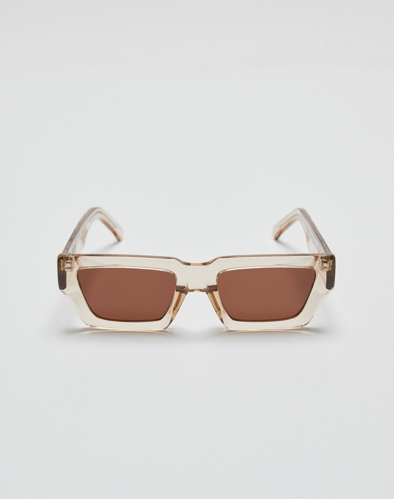The Live Fast Sunglasses by LIVE FAST DIE YOUNG feature rectangular frames in transparent beige Mazzuchelli acetate, brown-tinted UV-protective lenses, and a subtle silver logo, shown on a plain white background.