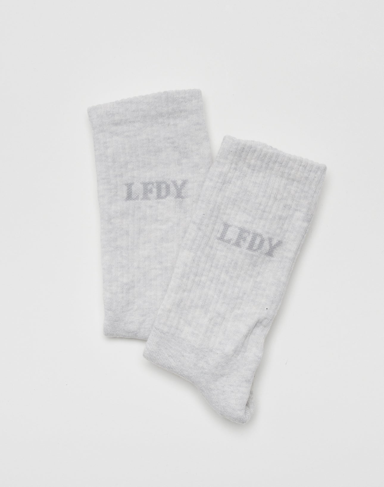 The LIVE FAST DIE YOUNG LFDY Logo Socks (2 Pack) features light gray socks with a slightly darker gray LFDY logo on each, shown against a plain white background.