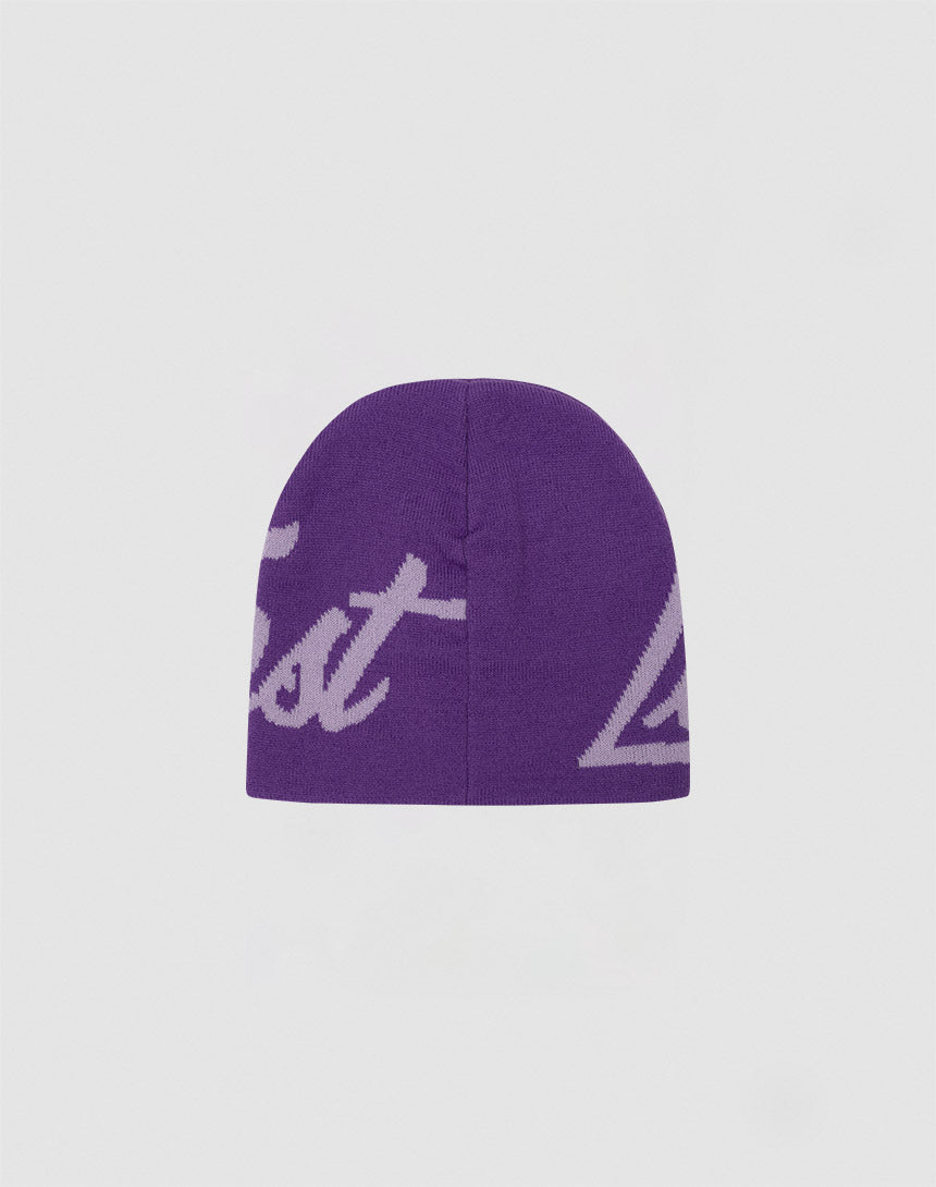 The LFDY Jacquard Beanie by LIVE FAST DIE YOUNG is a purple Polyacryl knit with partially visible white cursive Logo Strick text, shown on a plain light grey background.