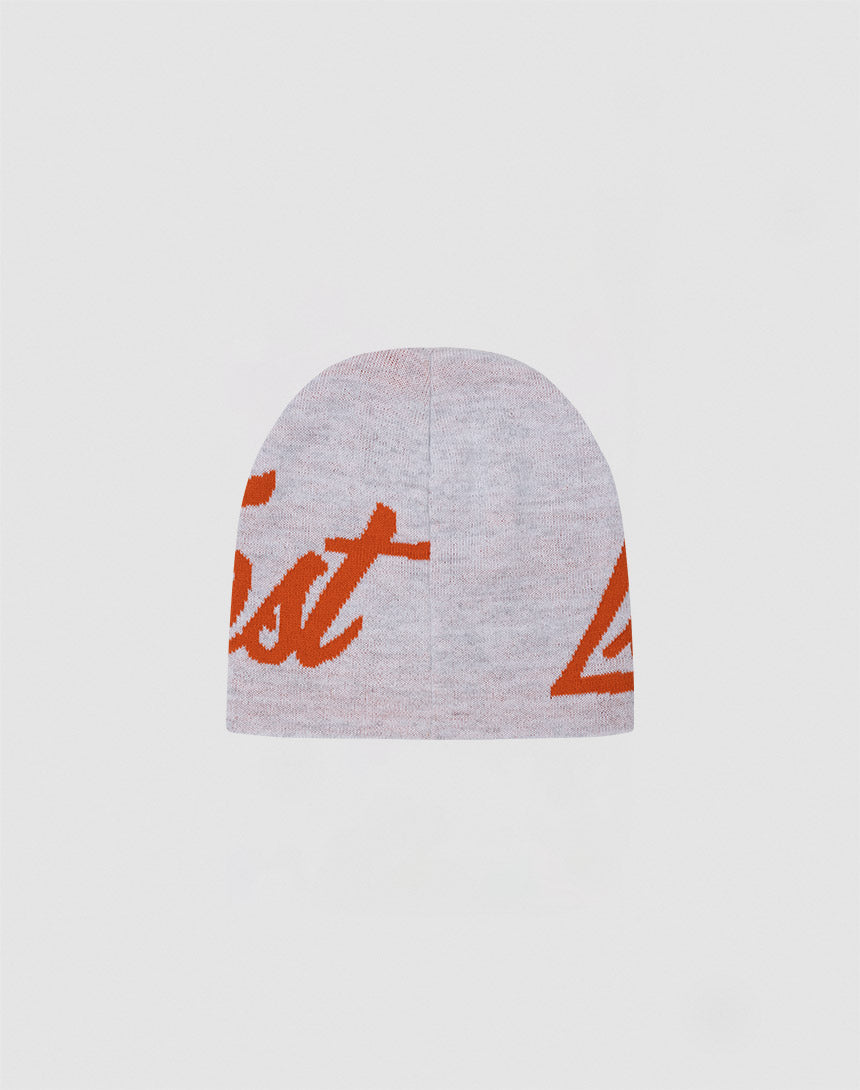 The LFDY Jacquard Beanie by LIVE FAST DIE YOUNG is a light gray Polyacryl hat with oversized orange script partially visible on the front, shown on a plain background. LF2411-16807 One Size offers versatile fit and standout style.