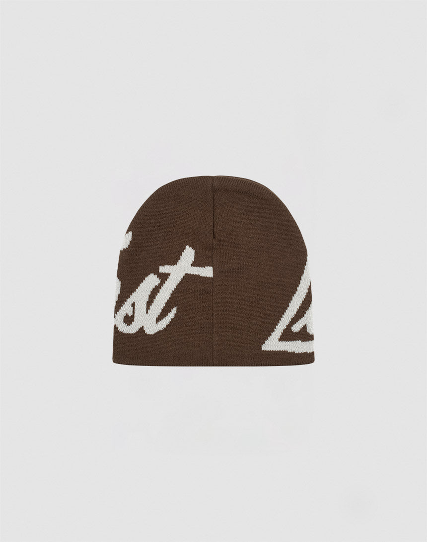 The LFDY Jacquard Beanie by LIVE FAST DIE YOUNG is a brown, soft Polyacryl knit beanie with a large off-white script logo, partially visible against a plain light gray background.