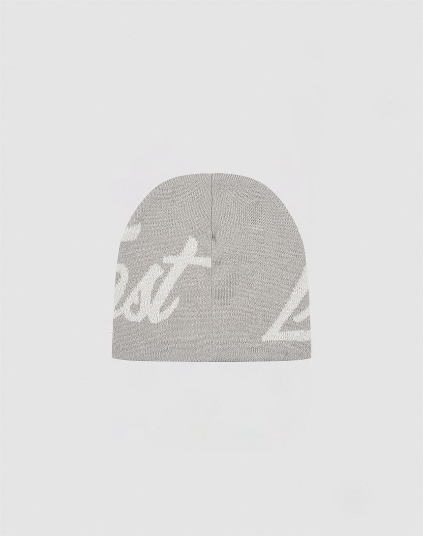 The LFDY Jacquard Beanie by LIVE FAST DIE YOUNG is a gray, 100% Polyacryl knit hat featuring white, partially visible “Logo Strick” cursive lettering on the front, shown against a simple light background.