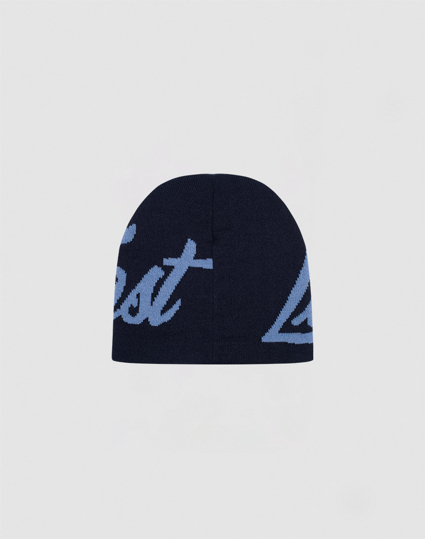 The LFDY Jacquard Beanie by LIVE FAST DIE YOUNG is a dark navy blue Polyacryl beanie with partially visible light blue cursive text, displayed against a plain light background.