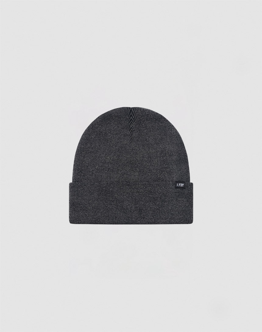 The LIVE FAST DIE YOUNG Basic Beanie is a dark gray cotton hat with a folded brim and a small rectangular tag on the left side, shown on a light gray background. Care instructions are provided for easy maintenance.