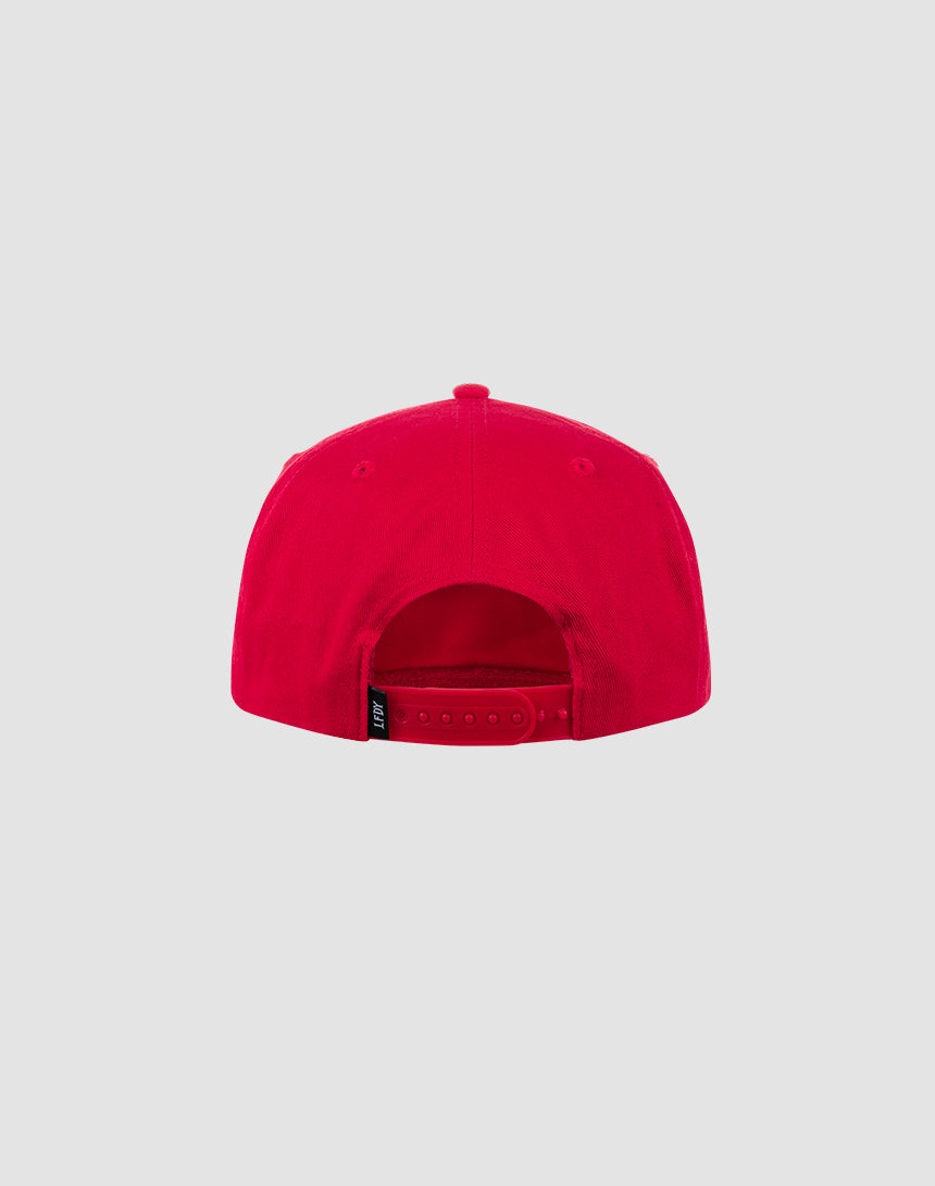 The Live Fast Unstructured Cap by LIVE FAST DIE YOUNG is a bright red baseball cap with an adjustable Mit Snapverschluss closure and a small black Logo-Stick tag on the strap, shown from the back against a light gray background. One size fits most.