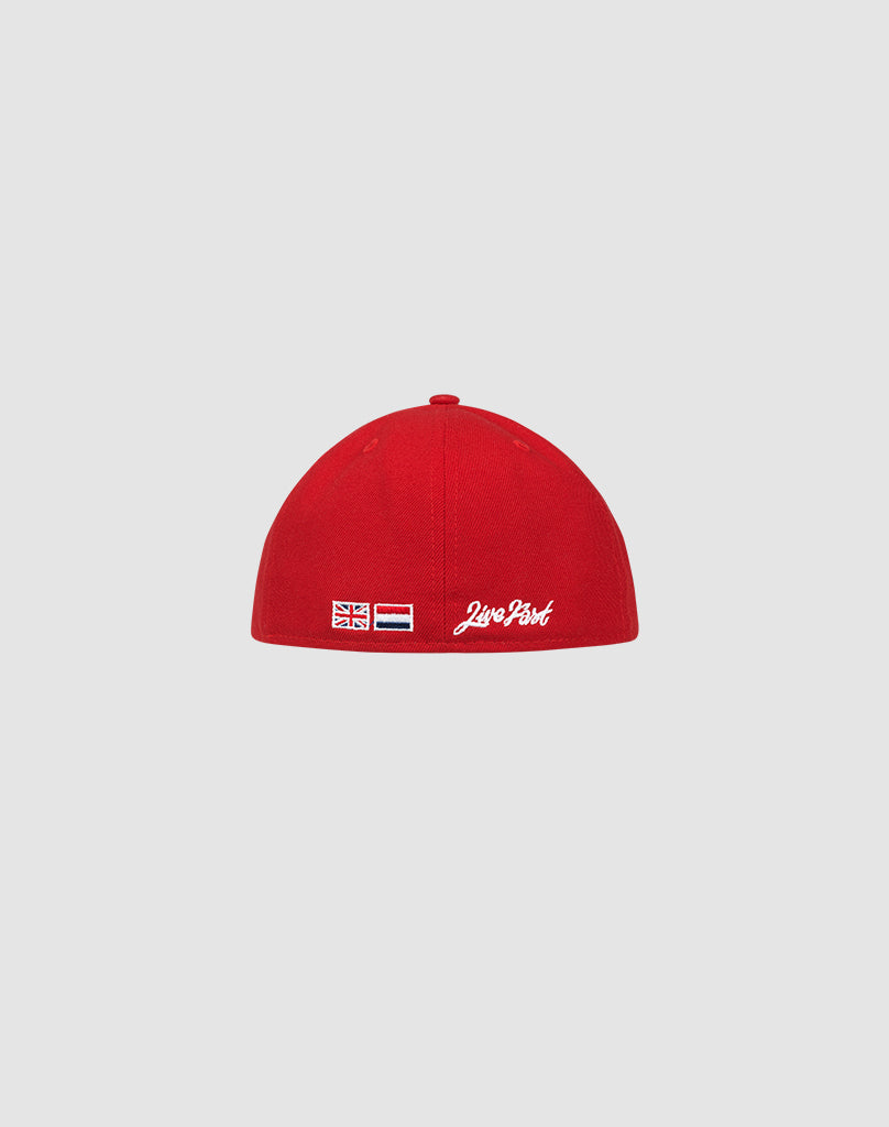 A red LFDY X NEW ERA 59FIFTY Low Profile Fitted Cap by LIVE FAST DIE YOUNG is shown from the back, with two small flag patches and white script embroidery on the side, set against a plain light gray background.