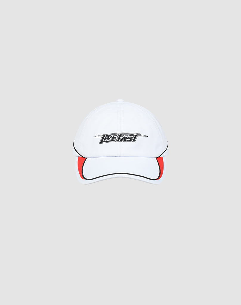 The Live Fast 3000 Cap by LIVE FAST DIE YOUNG is a white baseball cap with black piping, a red brim accent, and LIVE FAST in bold on the front. Features an adjustable Klettverschluss. Shown on a light gray background.