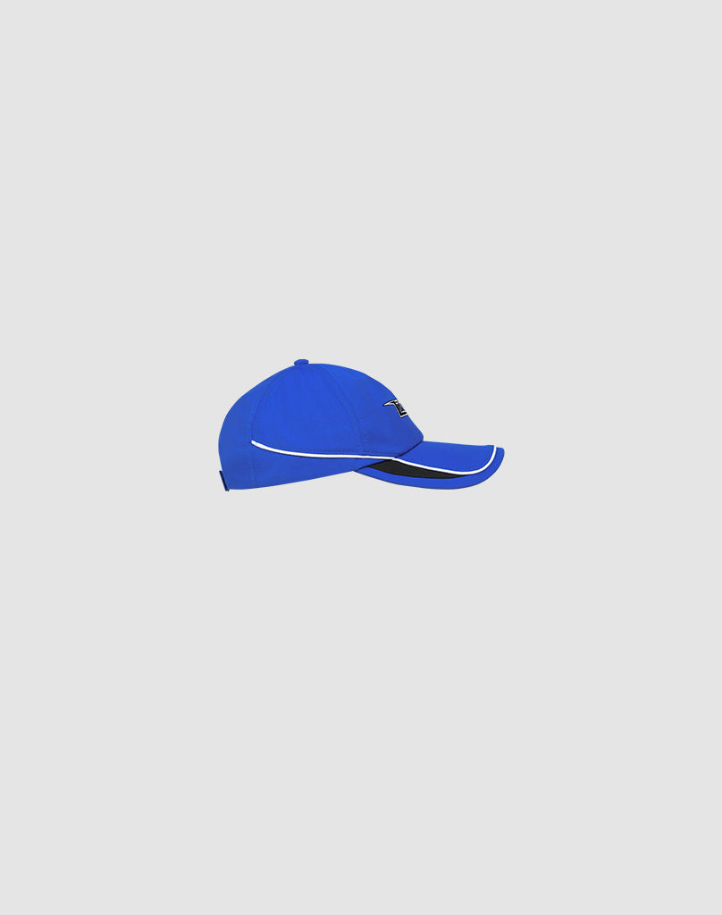 The LIVE FAST DIE YOUNG Live Fast 3000 Cap is a blue polyester baseball cap with white trim and a small black Logo-Stick on the side, featuring a Klettverschluss, shown on a plain light gray background.