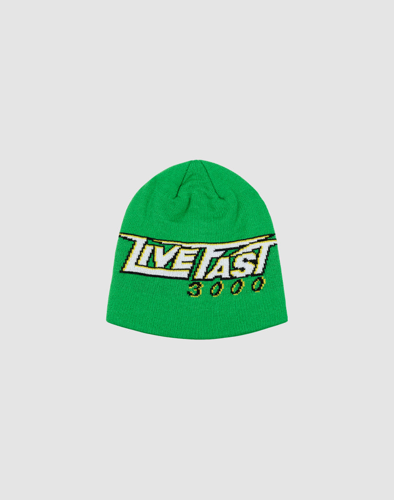 The Live Fast 3000 Beanie by LIVE FAST DIE YOUNG is a bright green polyacryl knit with a bold yellow, black, and white “LIVE FAST 3000” graphic on the front. Shown on a light gray background. One size fits all.