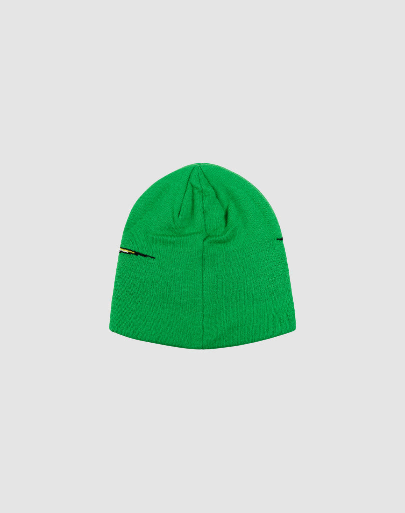 The LIVE FAST DIE YOUNG Live Fast 3000 Beanie is a green polyacryl knit hat with yellow, red, and black accents on one side, displayed on a light gray background. One size fits most.