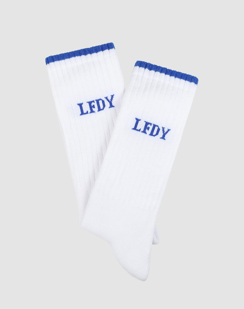 Basic Stripe Socks (2 Pack) by LIVE FAST DIE YOUNG: Two white ribbed socks with blue cuffs and LFDY embroidered in blue, made from 75% Baumwolle. Displayed as a set of two on a light gray background.