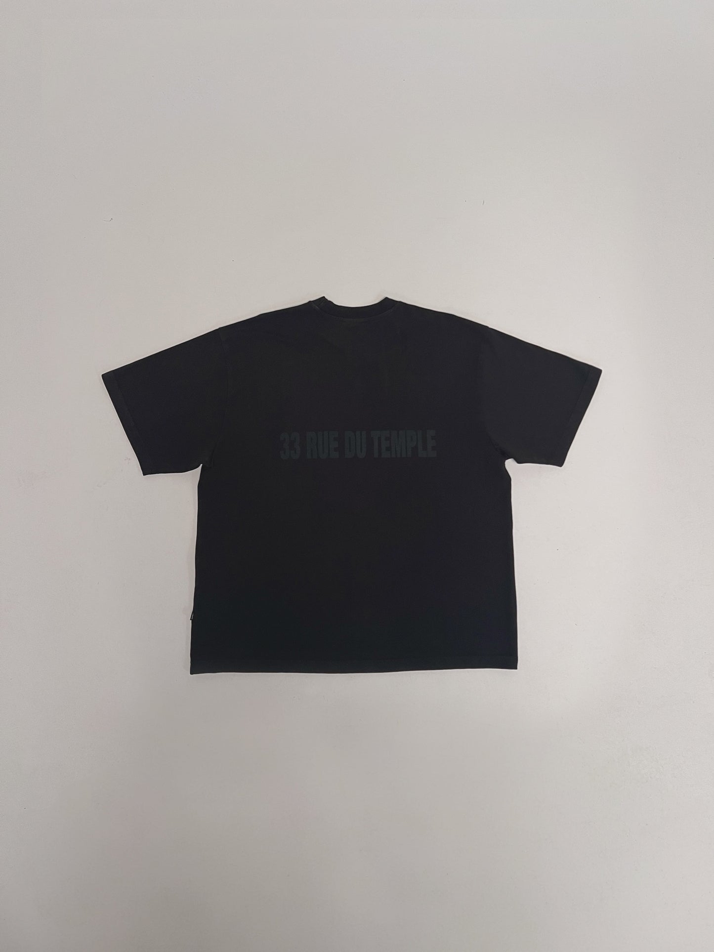 The LFDY Family & France Tee by LIVE FAST DIE YOUNG is a black oversized short-sleeve T-shirt with "33 RUE DU TEMPLE" in dark print on the upper back and front and back prints, shown laid flat against a white background.