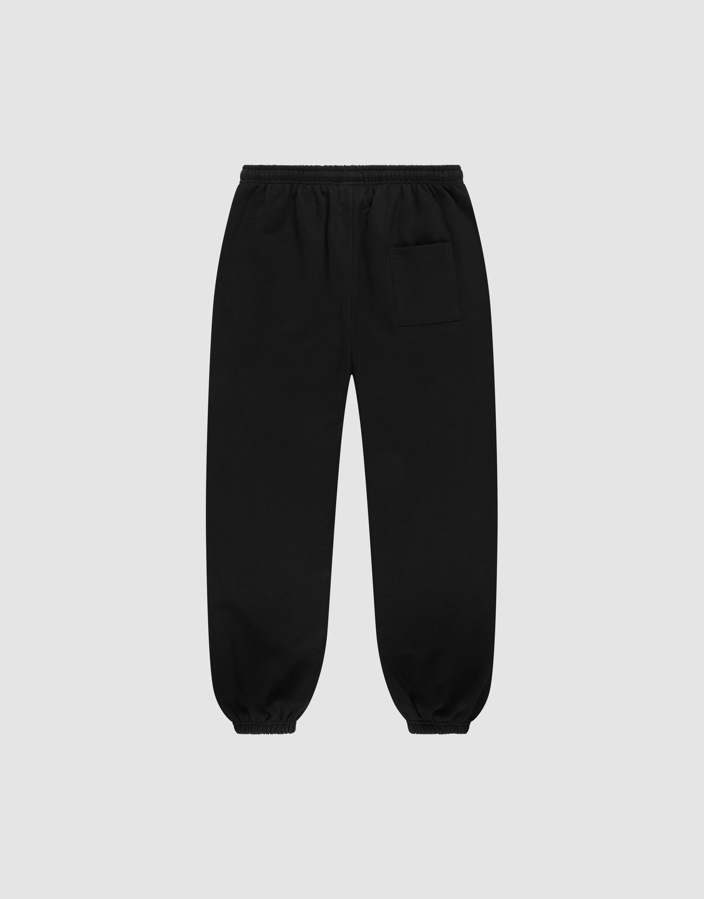 The LIVE FAST DIE YOUNG Wide Cuff Jogger is a black, wide-fit sweatpant made from 100% Baumwolle French Terry, featuring an elastic waistband, cuffs, and a small pocket on the upper right thigh, displayed on a light gray background.