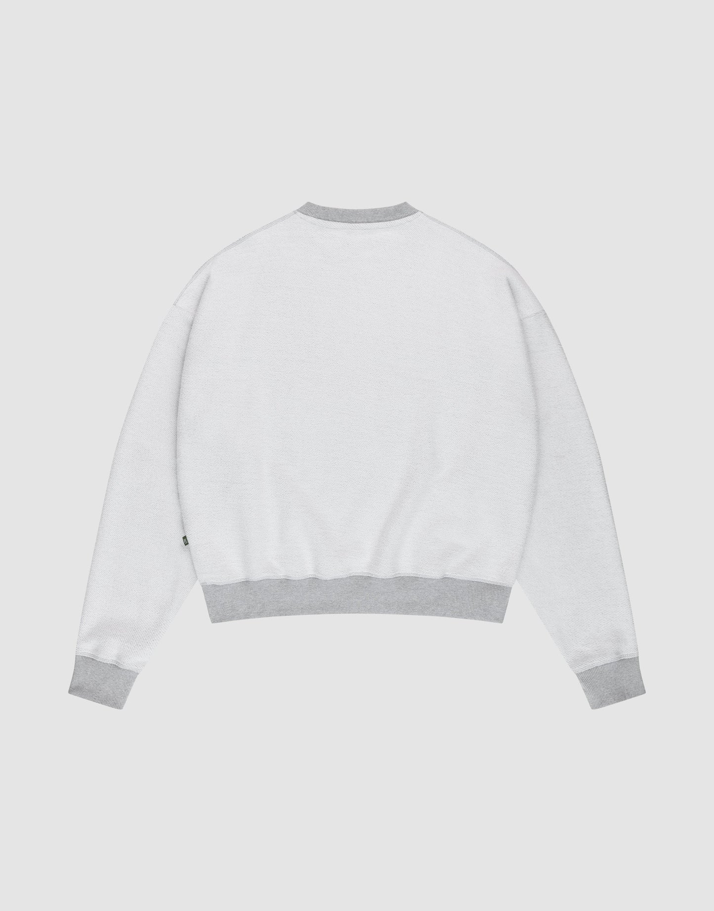 The LFDY District Sweater by LIVE FAST DIE YOUNG is shown from the back in an oversize fit, with light gray ribbed cuffs, waistband, and collar, displayed against a plain white background.
