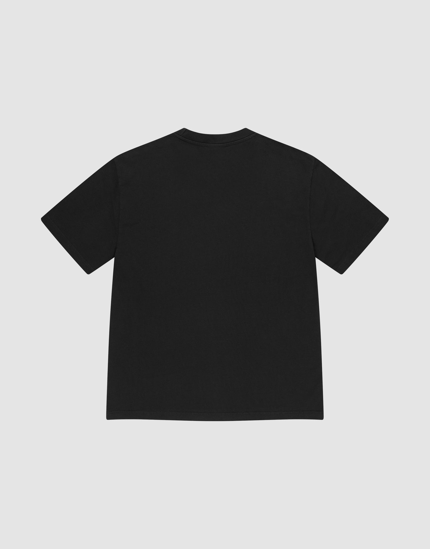 The LIVE FAST DIE YOUNG Basic Heavy Tee, an oversized black short-sleeve t-shirt made from 100% Baumwolle, is shown laid flat with the back facing up on a light gray background, featuring a subtle Flag-Label detail.