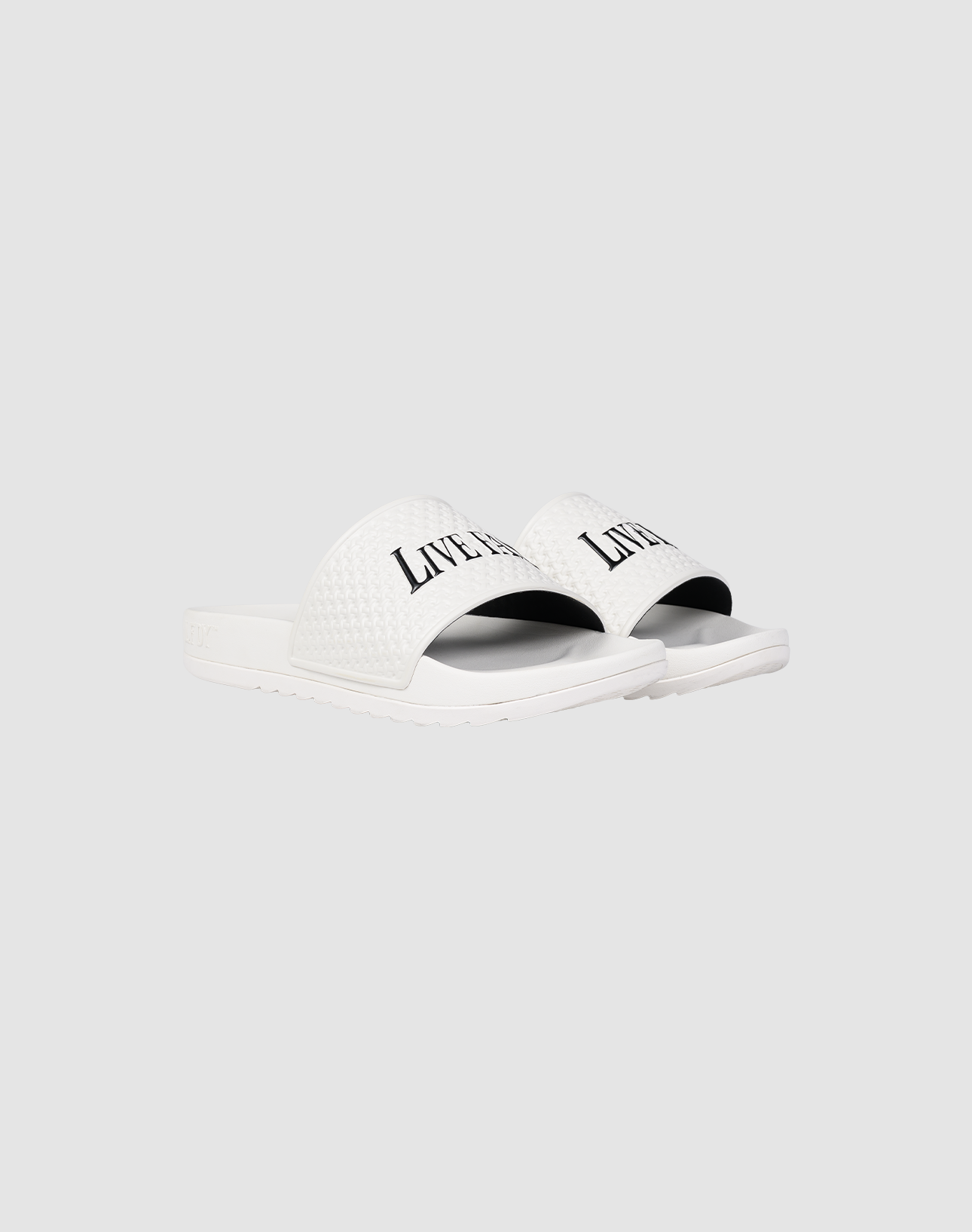 A pair of white LFDY Slides by LIVE FAST DIE YOUNG featuring a textured PU strap with "LIVERPOOL" printed in black, shown on a plain light gray background. | plain