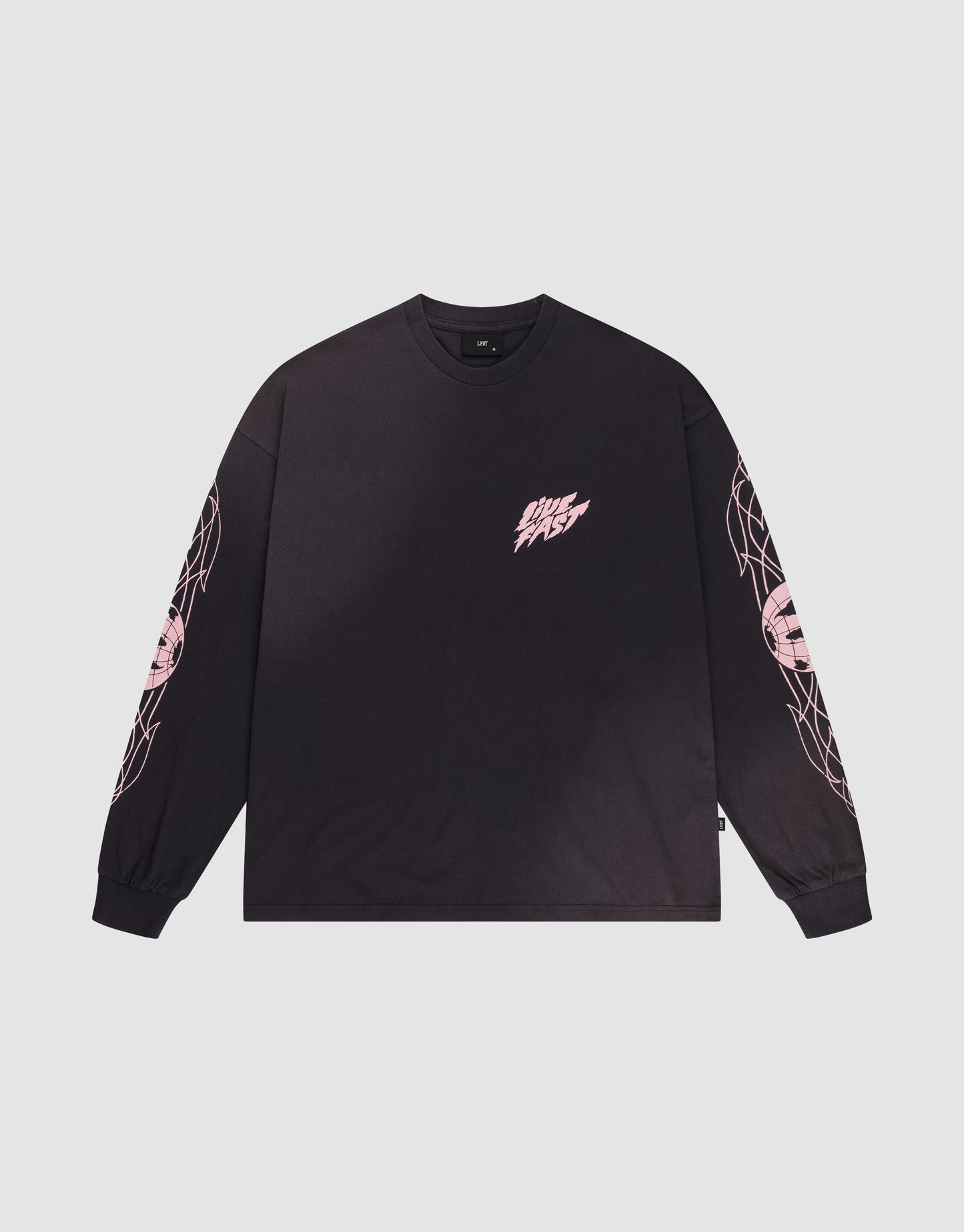 The LFDY Logo Longsleeve by LIVE FAST DIE YOUNG is a black, oversized tee with light pink graphics on both sleeves and a small pink DMS FAST logo on the left chest, shown laid flat on a white background.