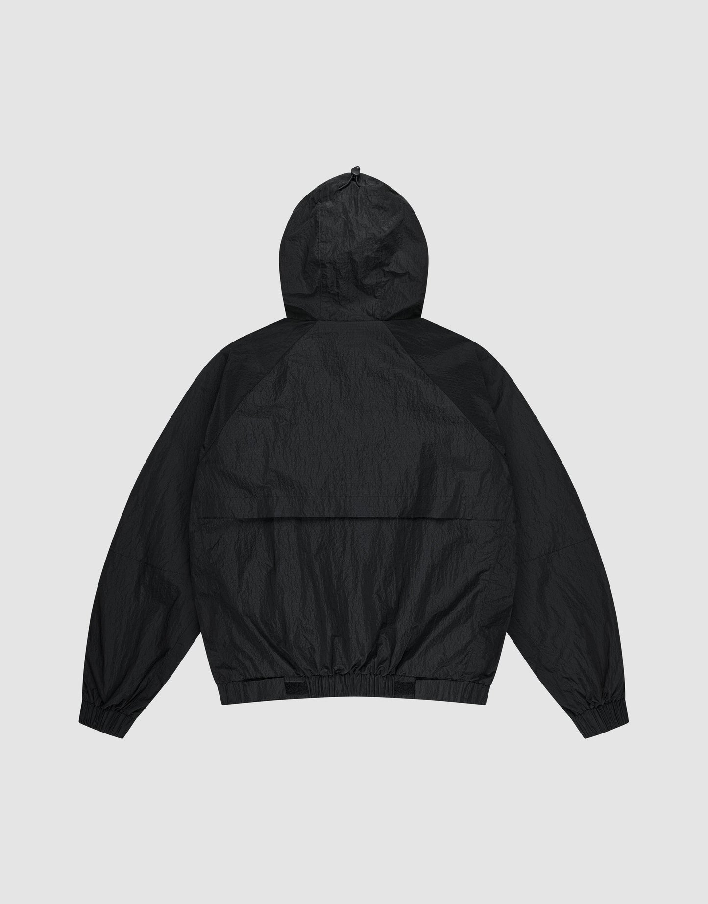 The Live Fast Nylon Jacket by LIVE FAST DIE YOUNG is shown flat from the back, featuring an oversized fit, long sleeves, elastic cuffs, and waistband, set against a light gray background.