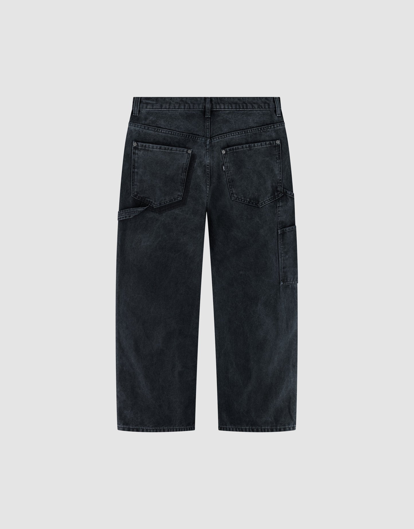 Back view of LFDY Carpenter Pants by LIVE FAST DIE YOUNG in black faded denim with a baggy fit, classic carpenter style, two large back pockets, and a side utility pocket, shown against a light gray background.