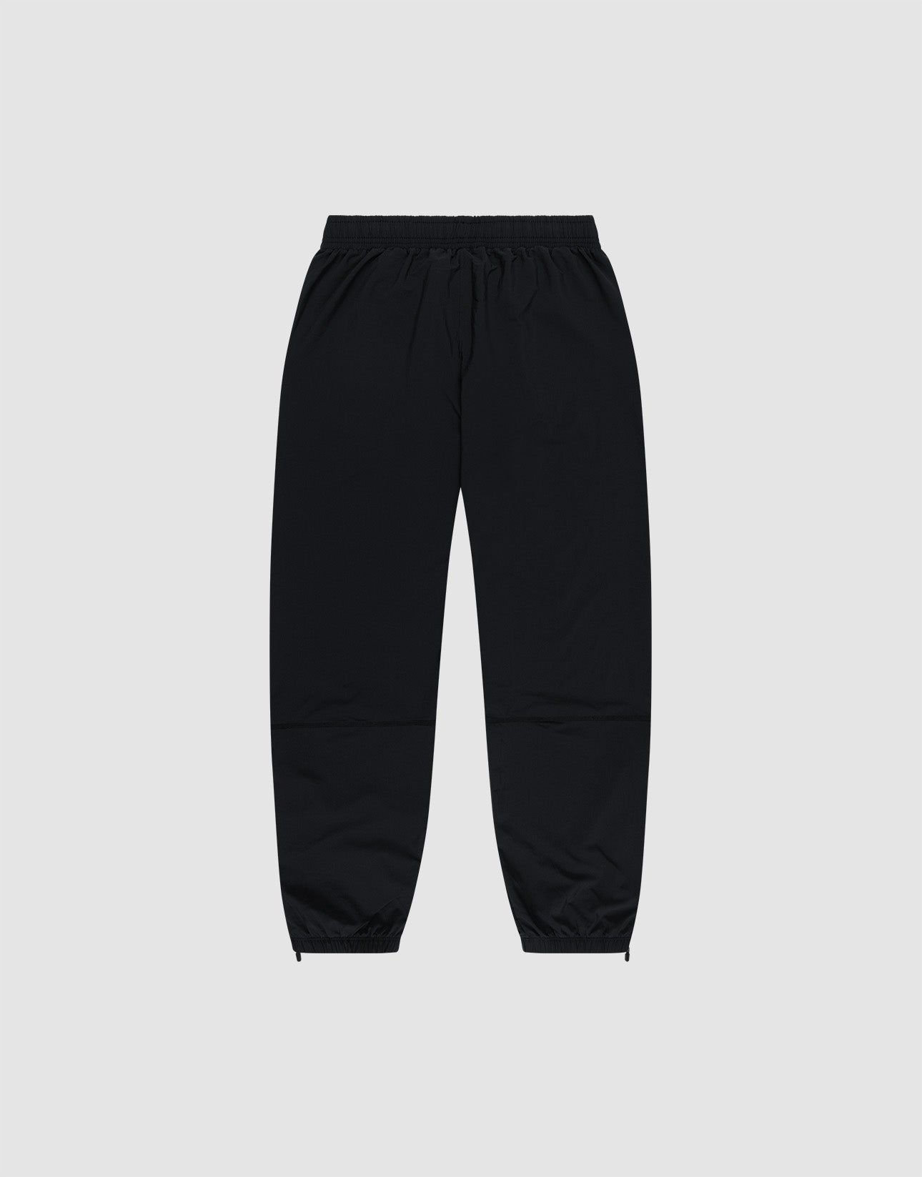 LIVE FAST DIE YOUNG's Live Fast Performance Running Pants feature an oversized fit, elastic waistband, and cuffed ankles, shown on a plain light gray background.