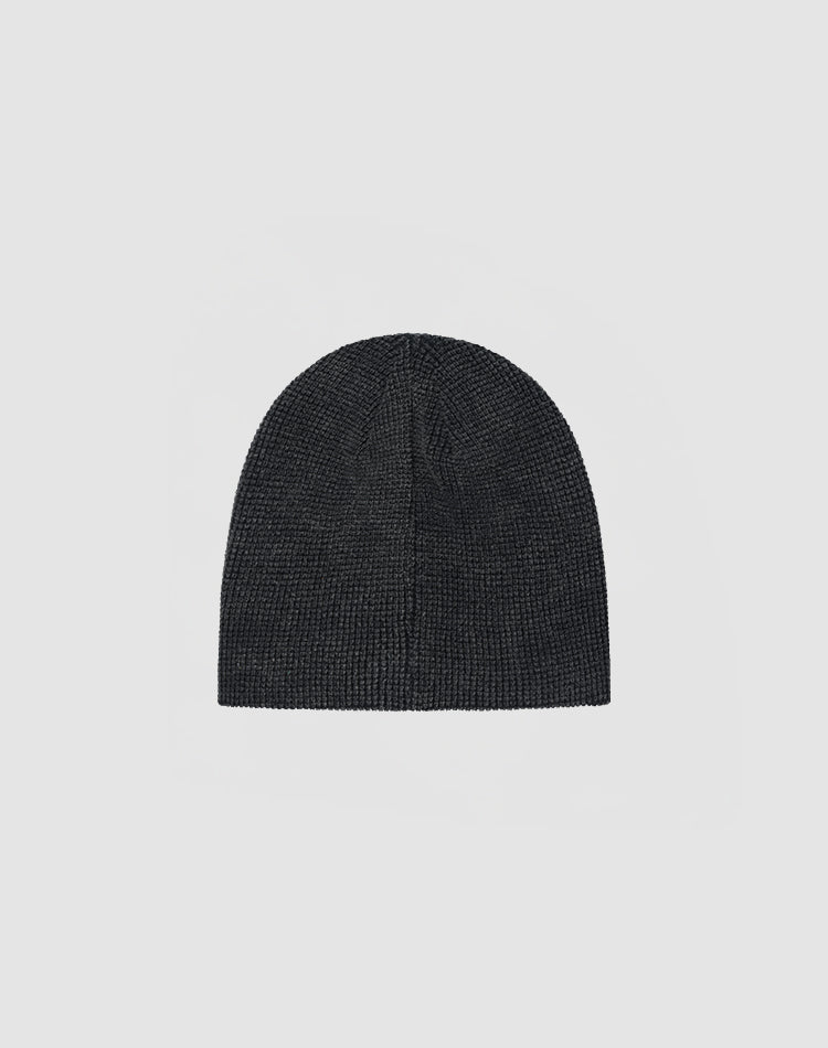 The DY Waffle Beanie by LIVE FAST DIE YOUNG in plain dark gray, made from 100% cotton, features a handcrafted spray effect for a unique look, shown against a light gray background.