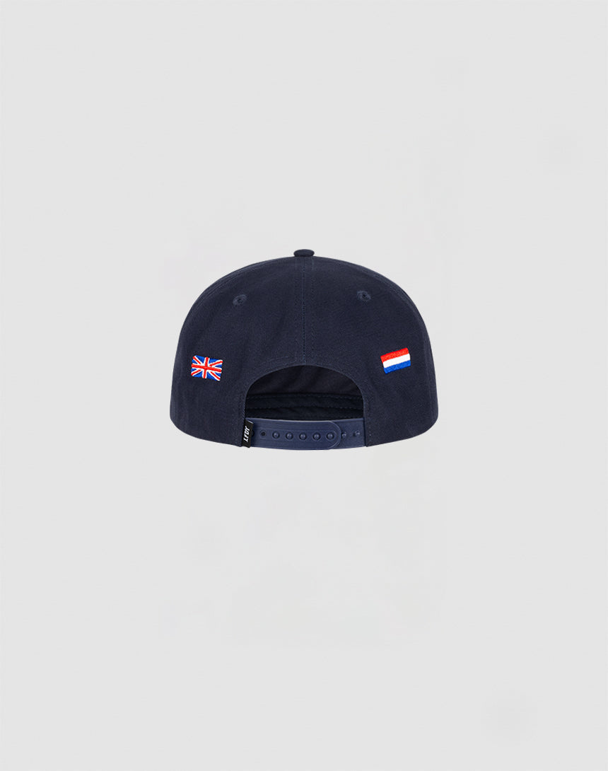 A navy blue Live Fast Corporation Cap by LIVE FAST DIE YOUNG, shown from the back with an adjustable strap. The Multi-Logo design features UK and Russian flag-labels on the sides against a plain light gray background.
