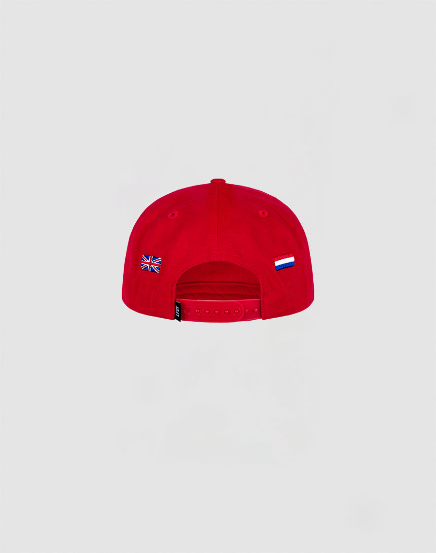 The Live Fast Corporation Cap by LIVE FAST DIE YOUNG is a red, 100% cotton cap with a multi-logo back design, featuring UK and Russian flag details on the sides and an adjustable strap in the center.
