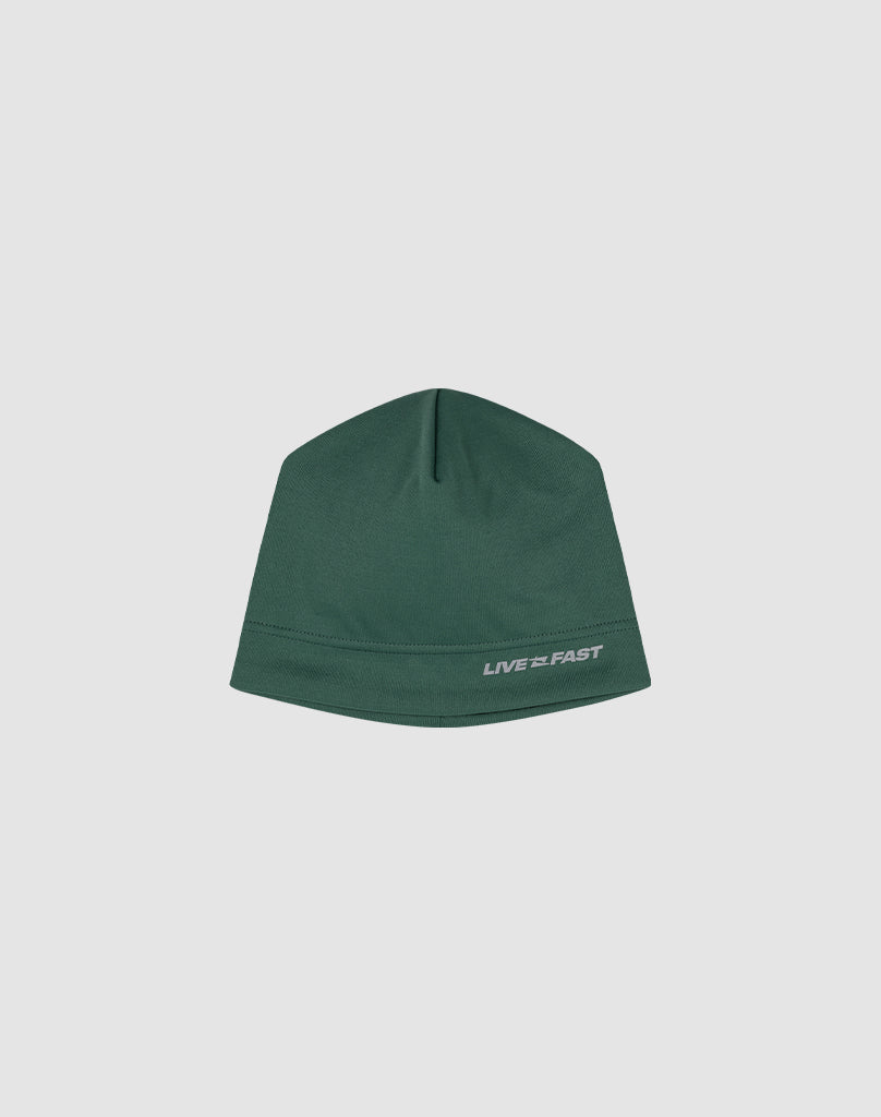 The Live Fast Performance Beanie by LIVE FAST DIE YOUNG is a fitted green hat featuring a small reflective white LIVE FAST logo print on the lower right, shown against a plain light gray background.