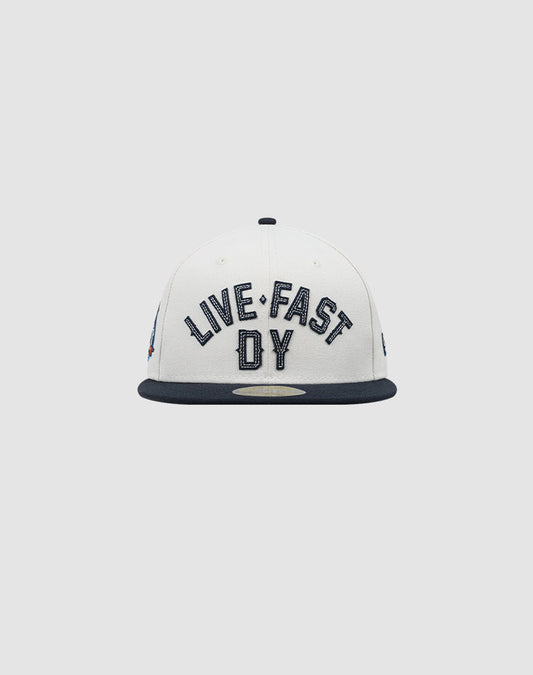 The LFDY X NEW ERA 59FIFTY by LIVE FAST DIE YOUNG is a white fitted cap with a dark brim, featuring bold LIVE FAST DY embroidery on the front. Größentabelle available for perfect sizing.