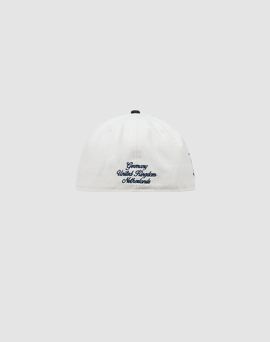 A white LFDY X NEW ERA 59FIFTY fitted cap by LIVE FAST DIE YOUNG, shown from the back with blue Germany United Kingdom Netherlands embroidery near the bottom. Plain light gray background. Größentabelle available for sizing.