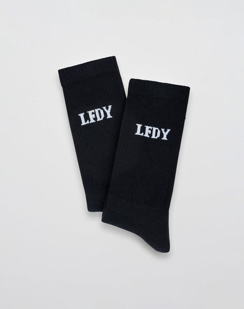 LIVE FAST DIE YOUNGs LFDY Logo Socks (2 Pack): Black socks crafted from a soft Baumwolle-Polyamid-Elastan blend, each featuring white embroidered LFDY lettering, shown flat on a light gray background. 