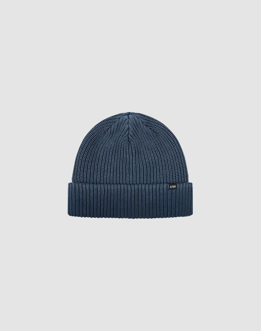 The LIVE FAST DIE YOUNG Double Rib Knit Beanie is blue with doppellagig gestricktem Design for a voluminöser Look, featuring a folded brim and small black front tag, shown on a plain light gray background.