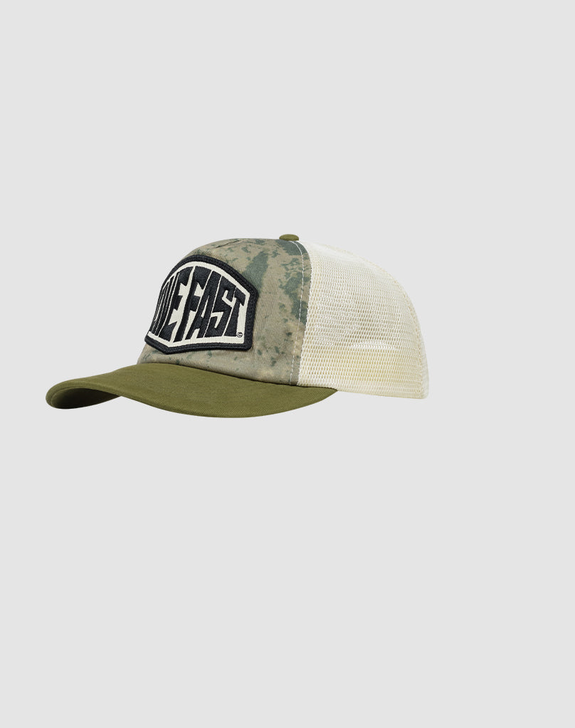 LFDY Patched Trucker by LIVE FAST DIE YOUNG: features a camouflage front, olive green brim, white mesh back, snap closure, and a bold LIVE FAST logo patch on the front.