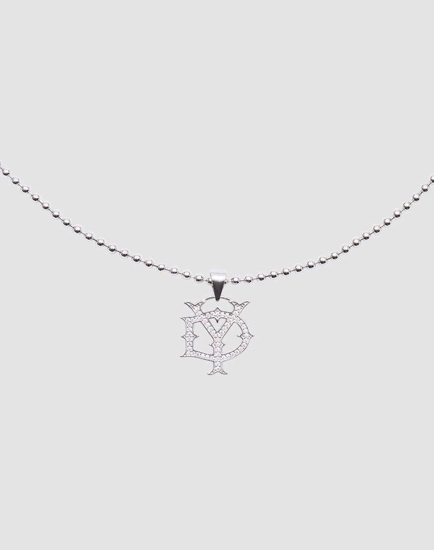 The DY Chain by LIVE FAST DIE YOUNG is a silver beaded necklace with a stylized D and Y pendant, encrusted with sparkling zirconia stones, crafted from sterling silver, shown on a plain light gray background.