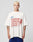 A man with short blond hair wears the LFDY Juveniles Tee by LIVE FAST DIE YOUNG, an oversized 100% Baumwolle shirt with red and blue “AMBITIOUS JUVENILES LIVE FAST DIE FAST” graphics, standing against a plain light background.