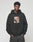 A young man with short curly hair wears the LFDY Sharkhunter Hooded by LIVE FAST DIE YOUNG, featuring front and back prints, posing with his hands in his pockets against a plain light background.