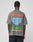 Someone wearing an oversize gray LFDY Metro Boomin Tee by LIVE FAST DIE YOUNG, featuring colorful back text: LIVE FAST, Main Event, METRO BOOMIN, Sunday, June 23, 2024, and an image of the Gateway Arch with trees.