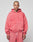 A person with a shaved head and neck tattoos wears the LIVE FAST DIE YOUNG Basic Hooded Zip and matching sweatpants in pink with a subtle fade effect, standing against a plain light gray background.
